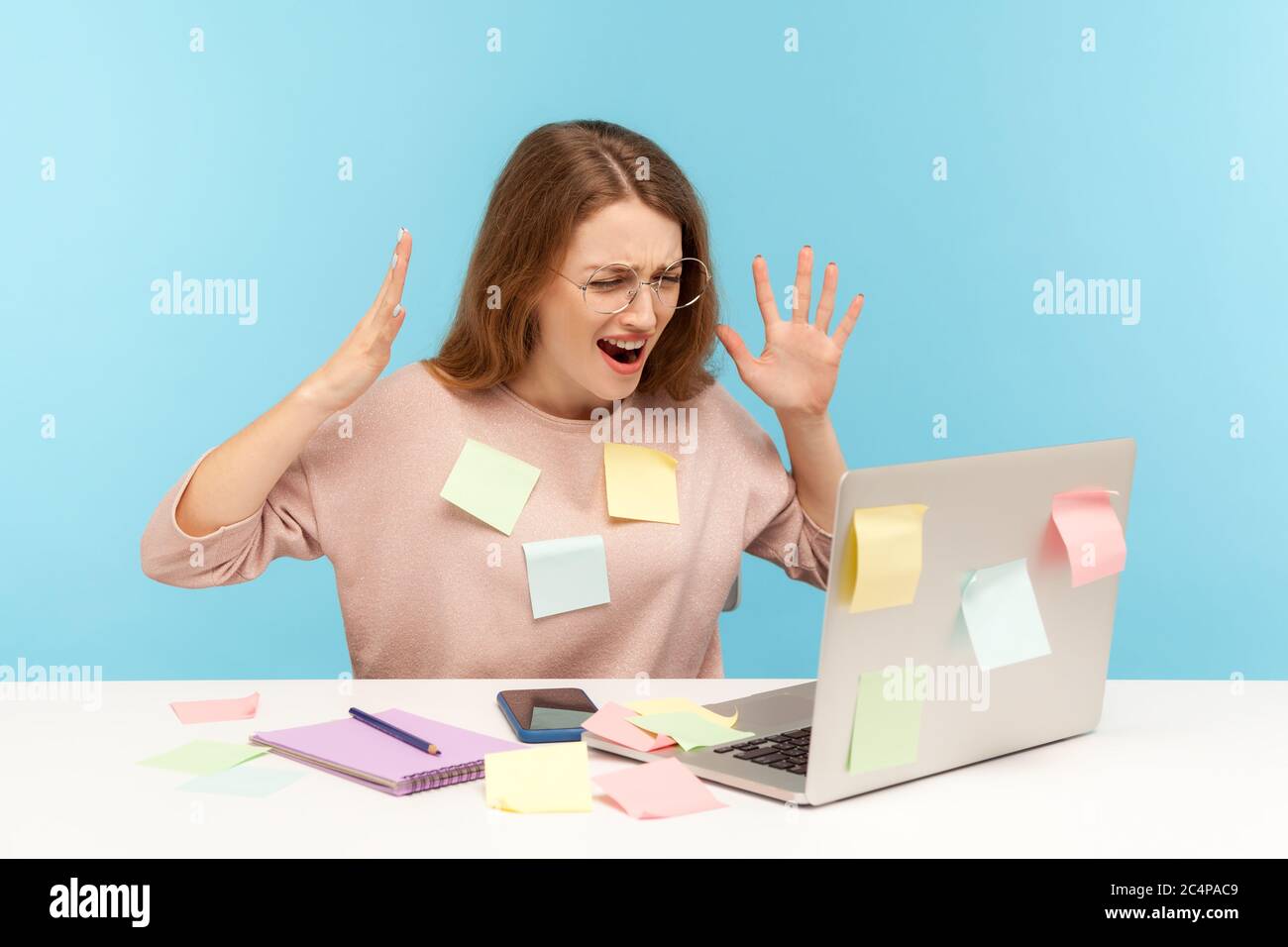 Depressed, stressed out, overworked woman employee in glasses covered with  sticky notes, angrily raising hands, screaming crazy in desperate at laptop  Stock Photo - Alamy, image size:1300x956