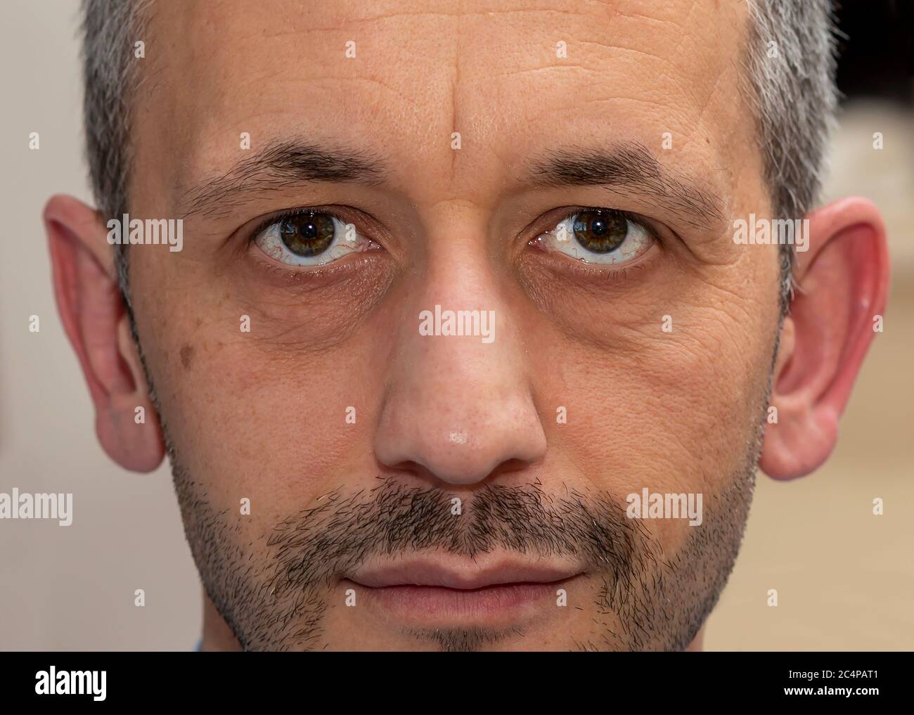 a causal white hair man eye. A green eye the causal man is looking at the camera Stock Photo