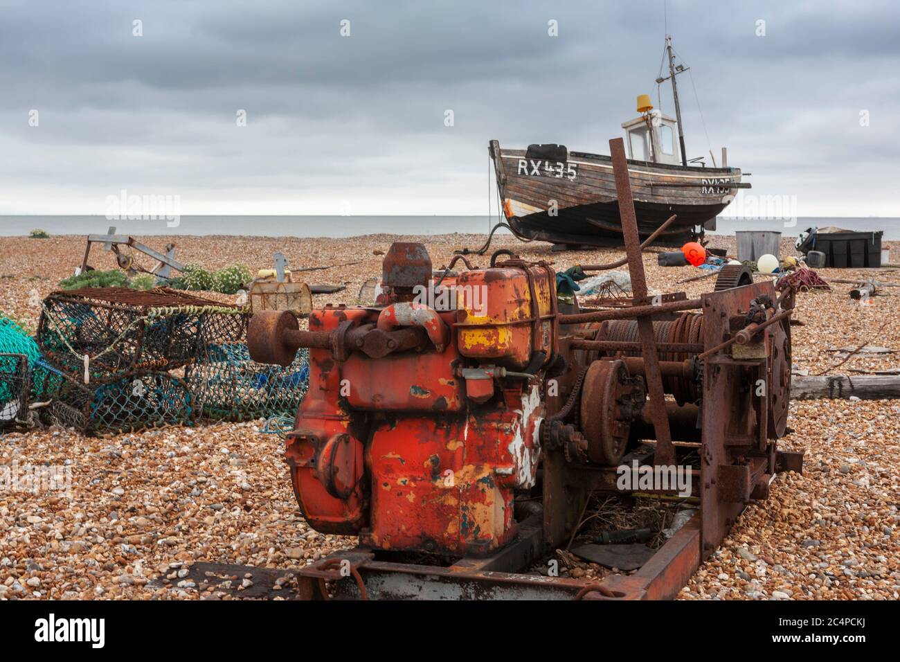Fishing boat and abandoned machinery on the shingle beach at Dungeness ...