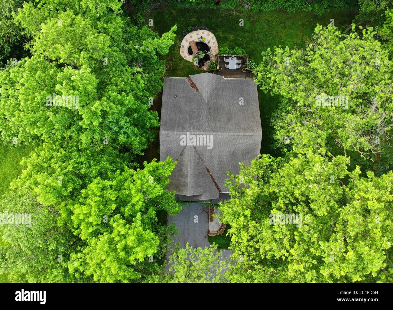 The aerial view of a house surrounded by green trees Stock Photo - Alamy