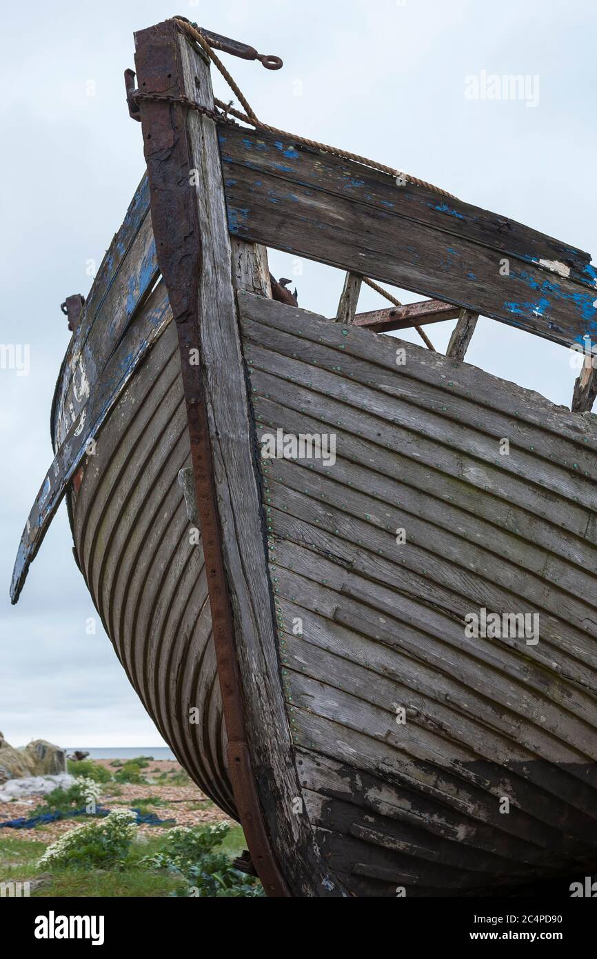 Fishing boat abandoned on the shingle beach at Dungeness, Kent, England ...