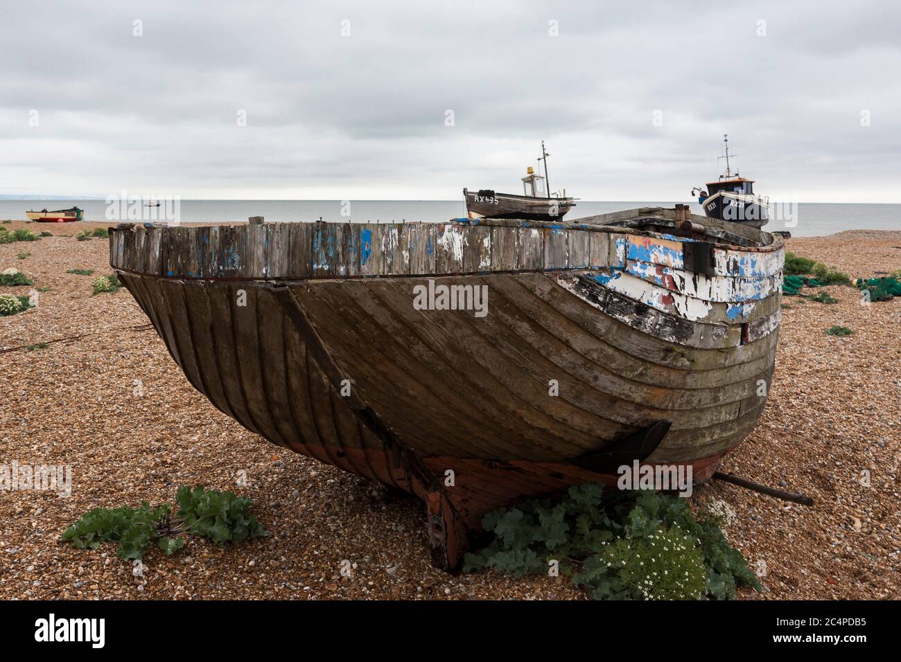Fishing boat abandoned on the shingle beach at Dungeness, Kent, England ...