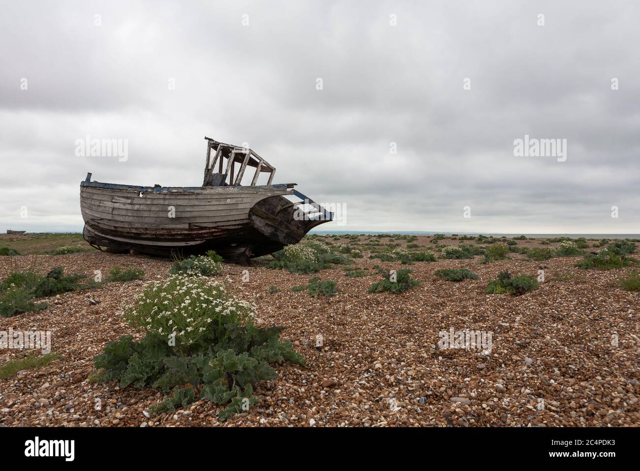 Fishing boat abandoned on the shingle beach at Dungeness, Kent, England ...