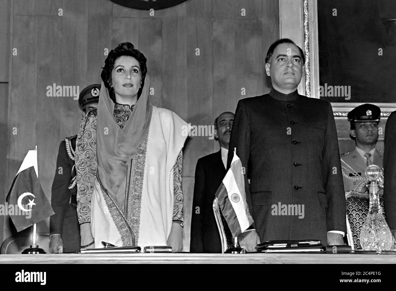 Pakistan Prime Minister Benazir Bhutto, left, and Indian Prime Minister Rajiv Gandhi stand together during the start of the fourth SAARC Summit meeting December 29, 1988 in Islamabad, Pakistan. The gathering of South Asian leaders includes Pakistan, India, Bangladesh, the Maldives, Sri Lanka, Bhutan and Nepal. Stock Photo