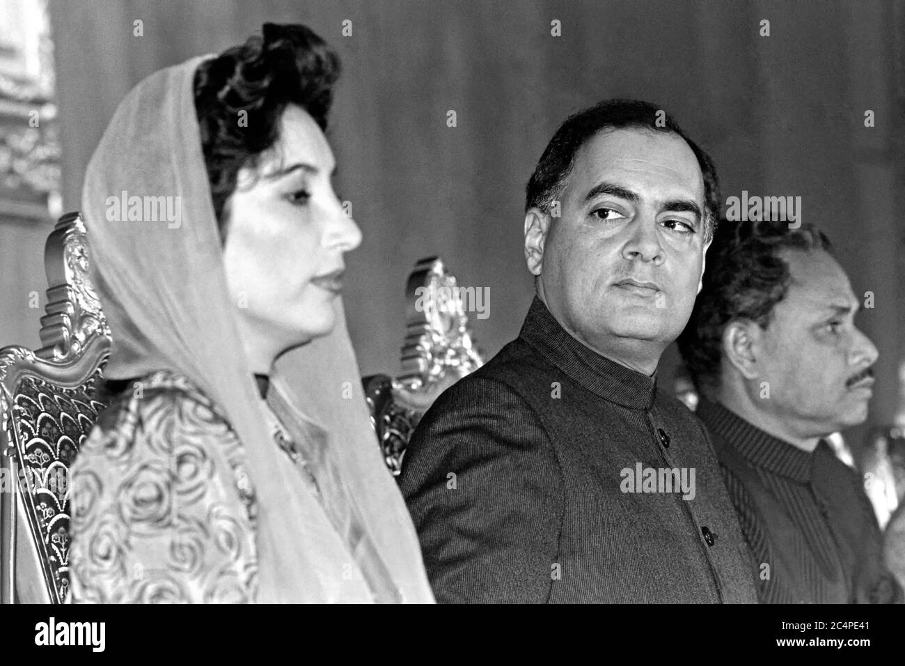 Indian Prime Minister Rajiv Gandhi looks toward Pakistan Prime Minister Benazir Bhutto, left, during the start of the fourth SAARC Summit meeting December 29, 1988 in Islamabad, Pakistan. The gathering of South Asian leaders includes Pakistan, India, Bangladesh, the Maldives, Sri Lanka, Bhutan and Nepal. Stock Photo