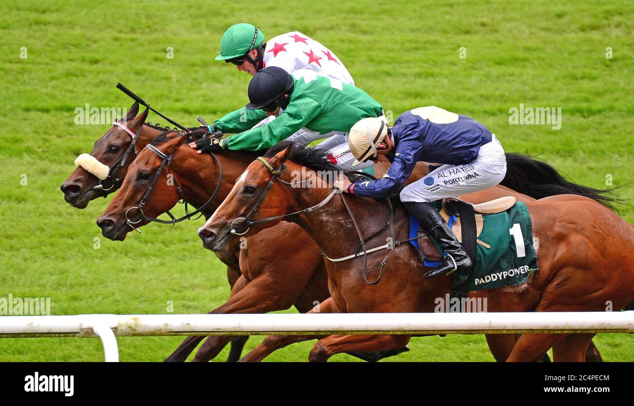 Strong Johnson and Colin Keane (black cap, green silks) on the way to winning The Paddy Power Rockingham at Curragh Racecourse. Stock Photo