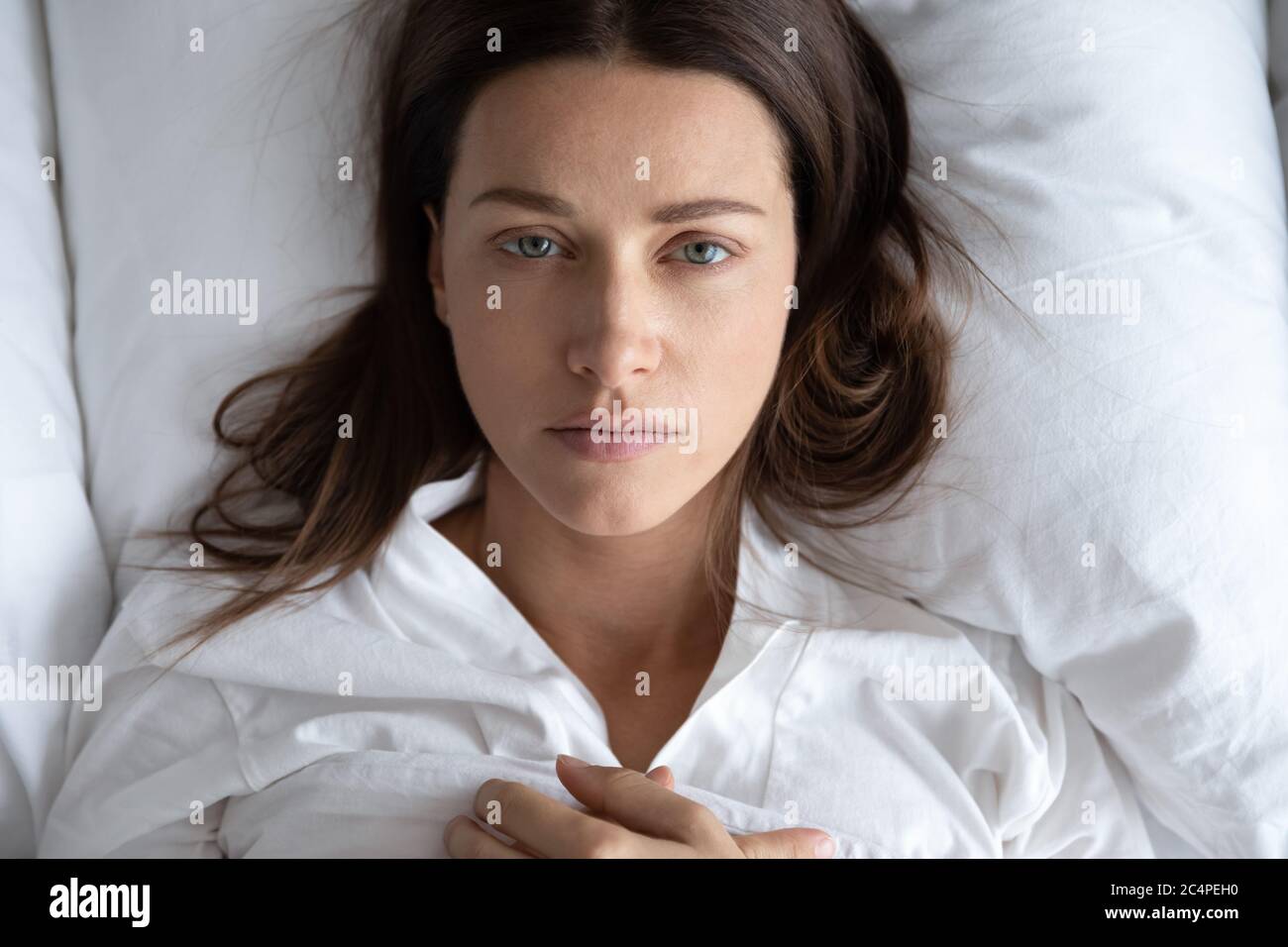 Depressed young woman rest in bed suffering from depression Stock Photo
