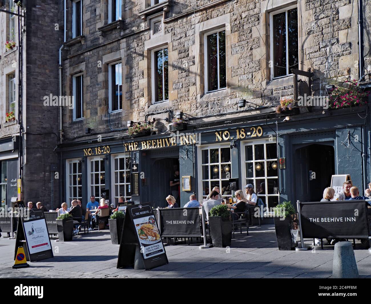 Edinburgh, Scotland  -  September 20, 2016: Grassmarket Square, with outdoor seating areas of restaurants in old stone buildings. Stock Photo