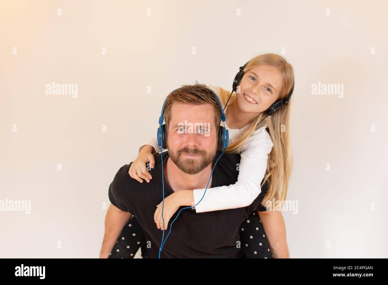 Father and daughter listening to music Stock Photo - Alamy