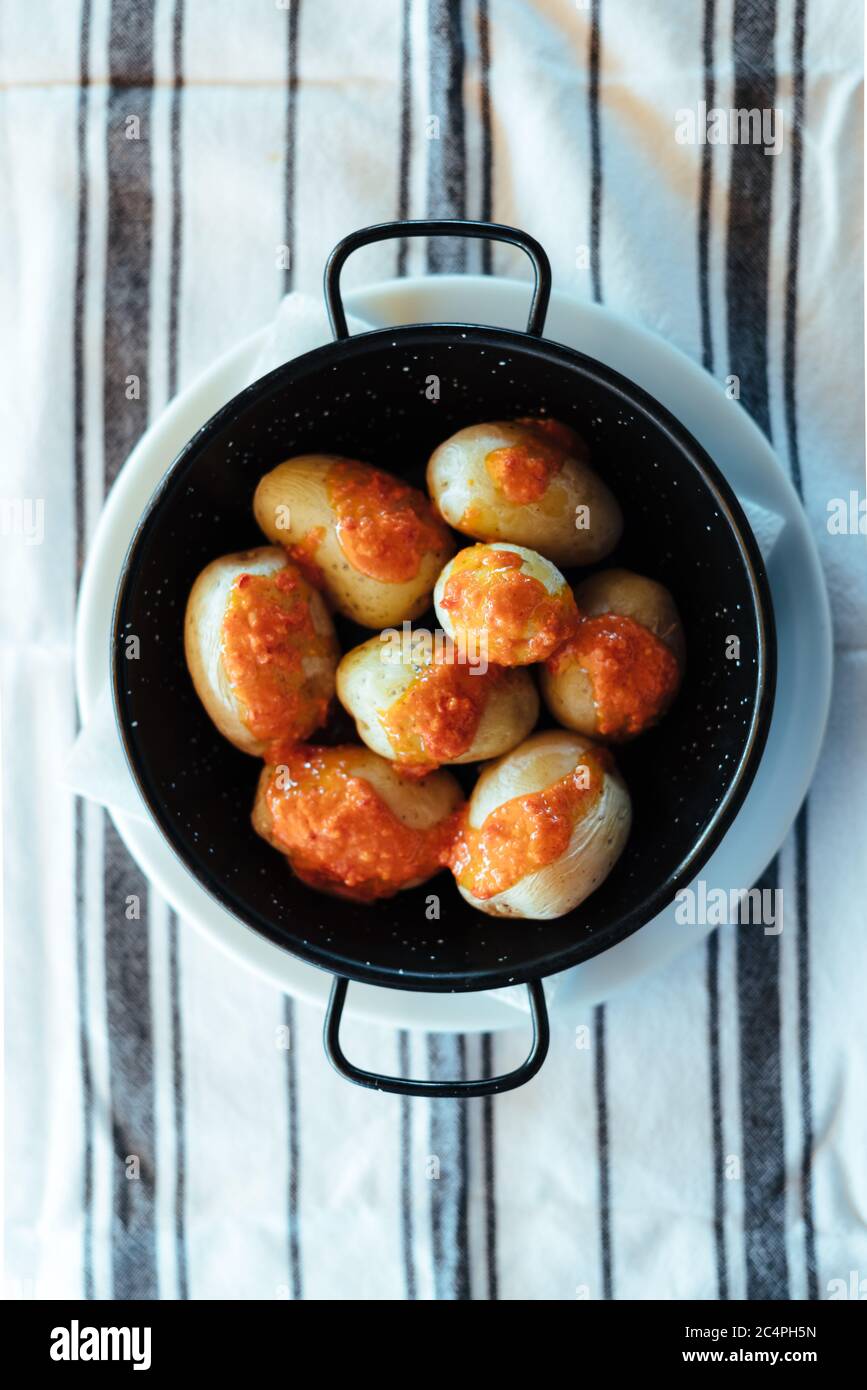 Canarian potatoes with mojo rojo at a restaurant in La Graciosa/Graciosa Island's Caleta del Sebo, Canary Islands, Spain Stock Photo