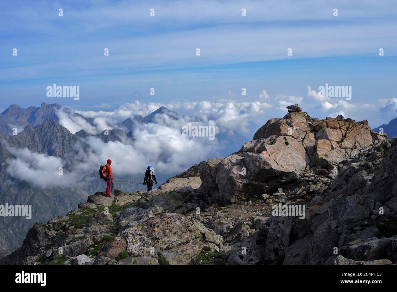 Mountaineers climb on a rocky rjdge, Alpi Marittime, Italy Stock Photo