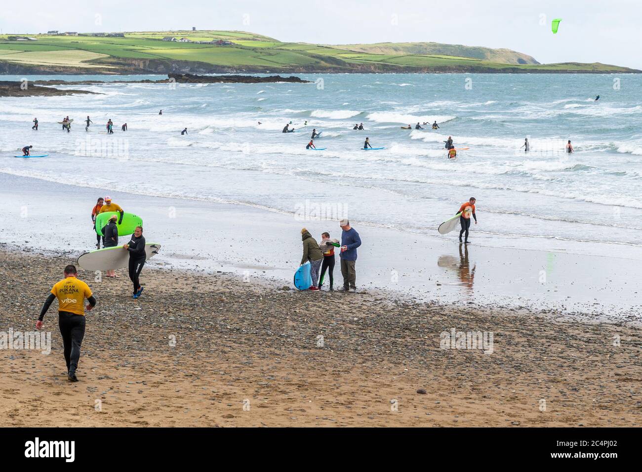 Garretstown, West Cork, Ireland. 28th June, 2020. On a very windy day at Garretstown Beach, there was a crowd of people attempting to surf some waves. Credit: AG News/Alamy Live News Stock Photo