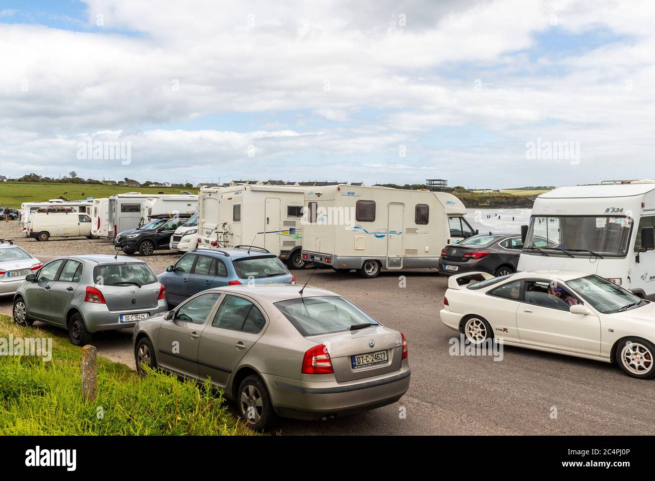 Garretstown, West Cork, Ireland. 28th June, 2020. Despite the near gale force winds, hundreds of tourists and locals alike descended on Garretstown Beach today. Credit: AG News/Alamy Live News Stock Photo
