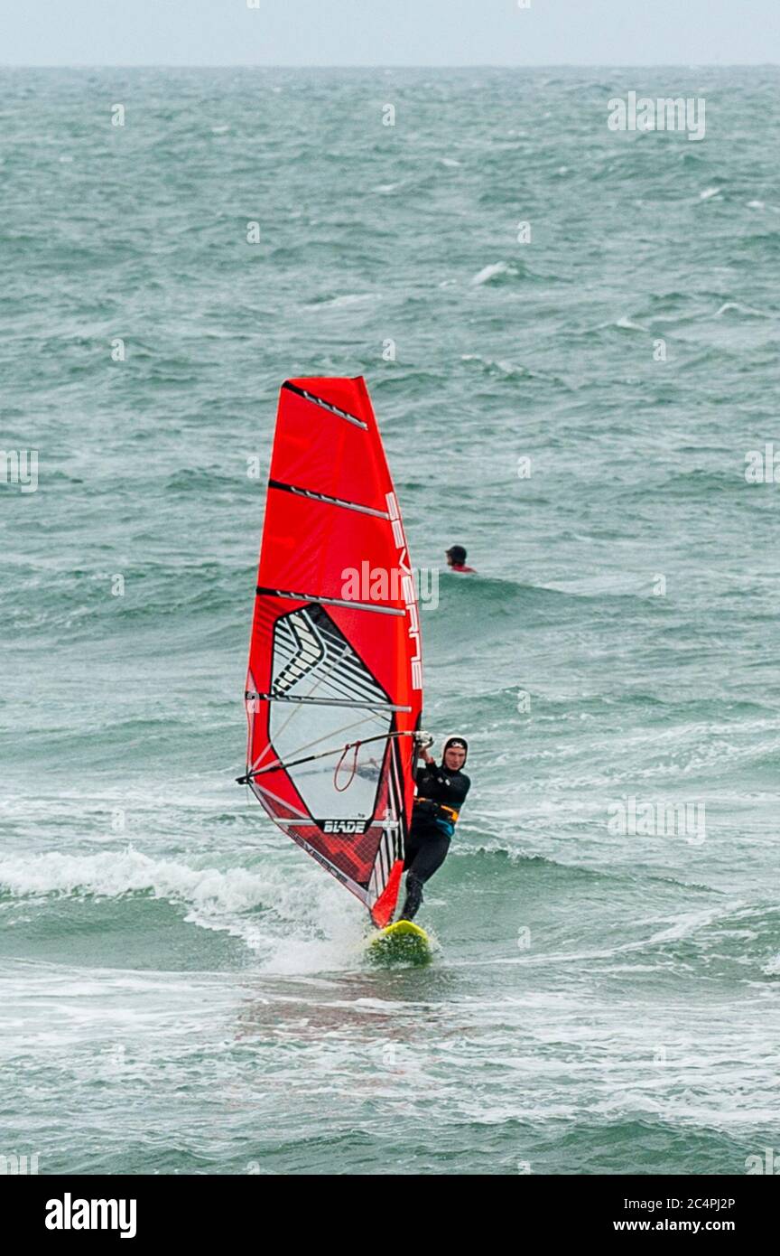 Garretstown, West Cork, Ireland. 28th June, 2020. Many wind surfers took advantage of the near gale force winds at Garretstown Beach today. Credit: AG News/Alamy Live News Stock Photo