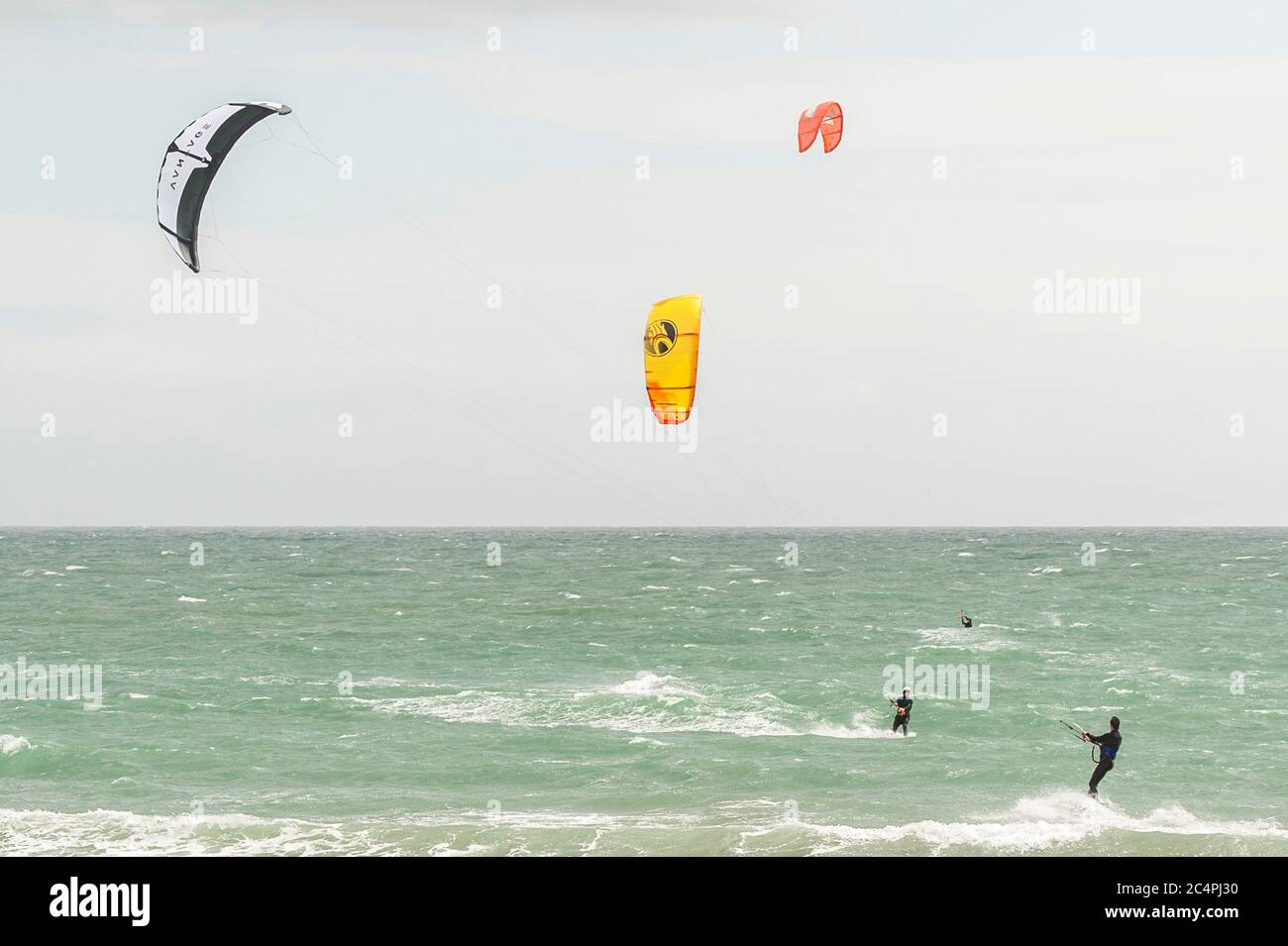 Garretstown, West Cork, Ireland. 28th June, 2020. Many kite surfers took advantage of the near gale force winds at Garretstown Beach today. Credit: AG News/Alamy Live News Stock Photo