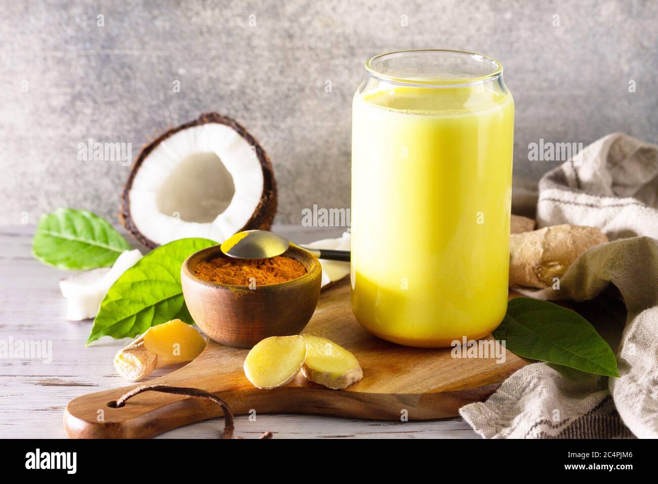 Cup of Healthy ayurvedic drink golden coconut milk turmeric iced latte