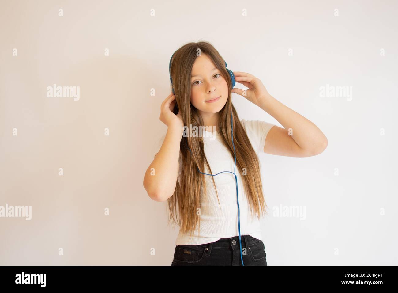 Girl with long hair listening to music Stock Photo - Alamy