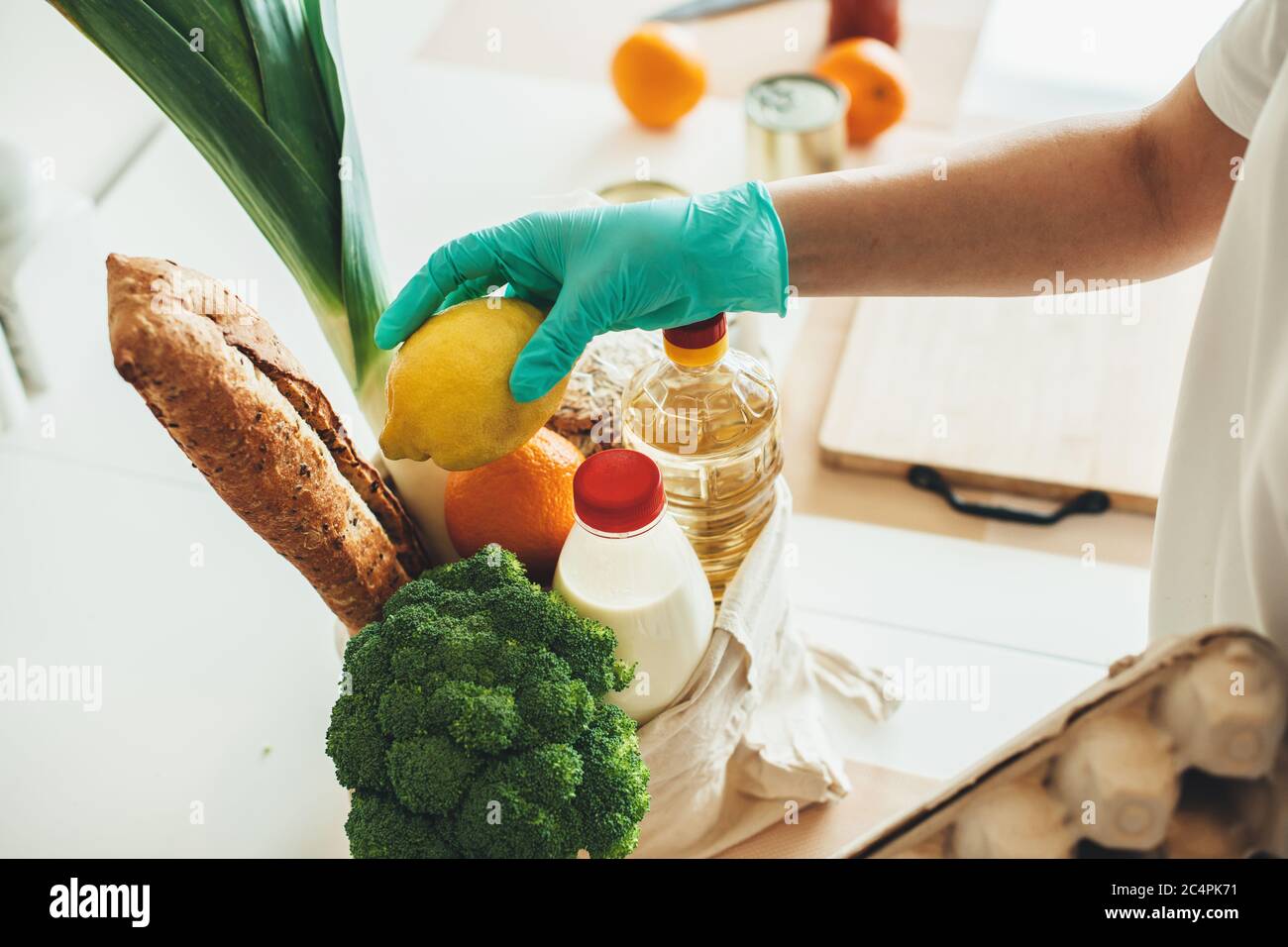 Caucasian person with gloves who got food through online delivery