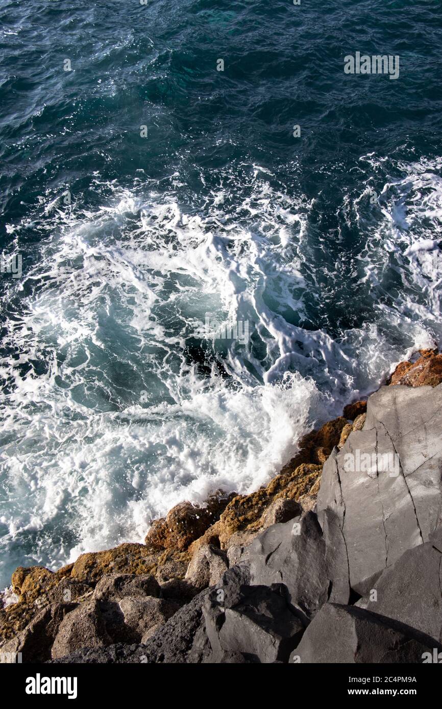 Beautiful waves crashing against the rocks Stock Photo