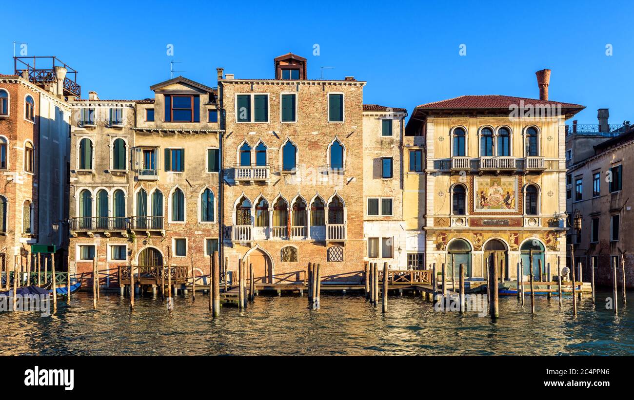 Vintage houses, Venice, Italy. Front view of facades of residential buildings on Grand Canal. Panorama of embankment in the Venice city center in summ Stock Photo
