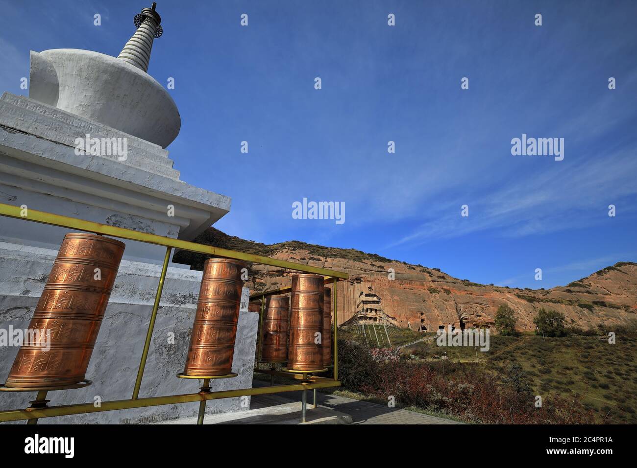 White stupa-blue sky-cirrus clouds-copper prayer wheels. Mati si-Horse Hoof Temple-Zhangye-Gansu-China-0960 Stock Photo
