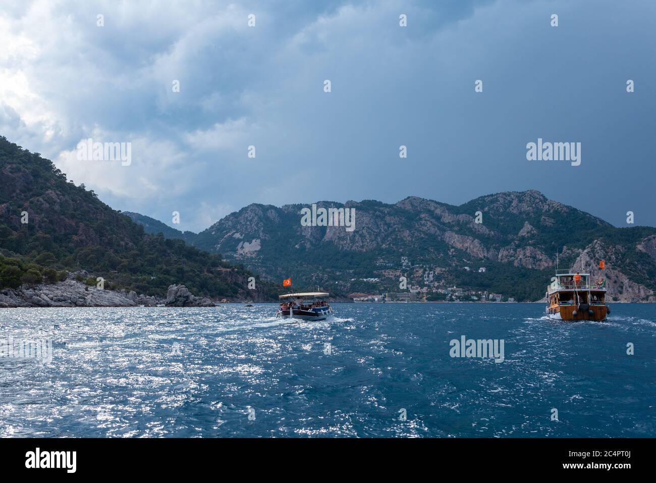 View from the bow of a sea boat on sea boats, mountains and stormy sky Stock Photo