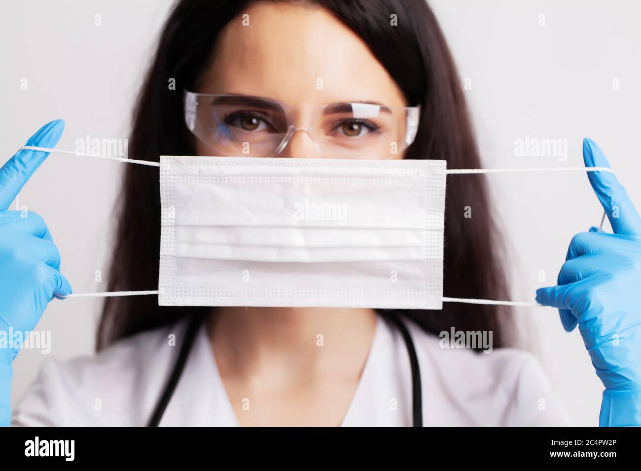 Professional puts face mask woman hi-res stock photography and images ...