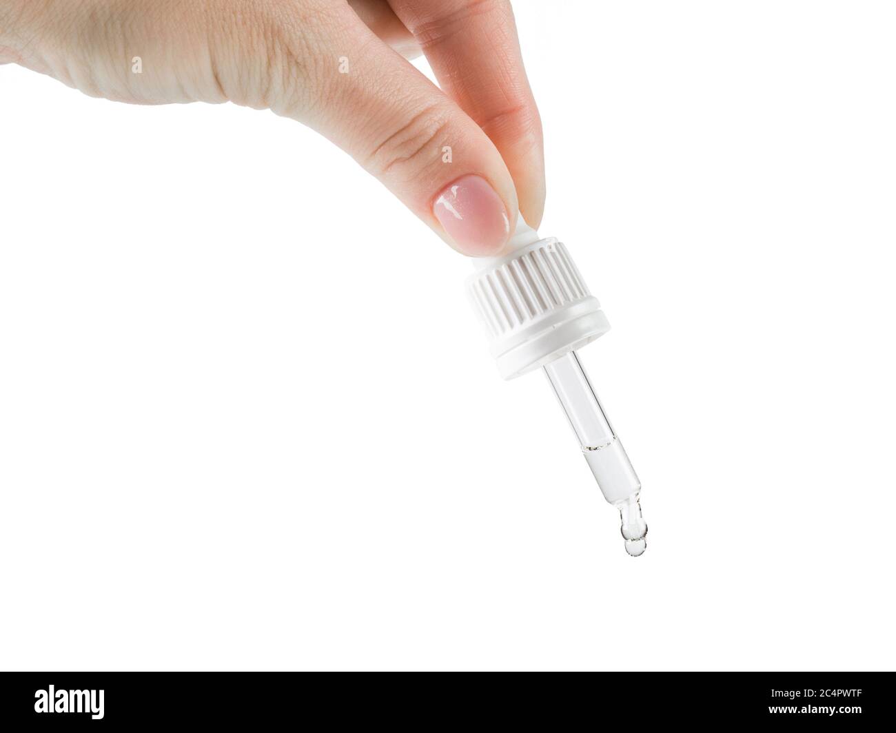 Hand squeezes a clear liquid out of the pipette. Isolated on a white