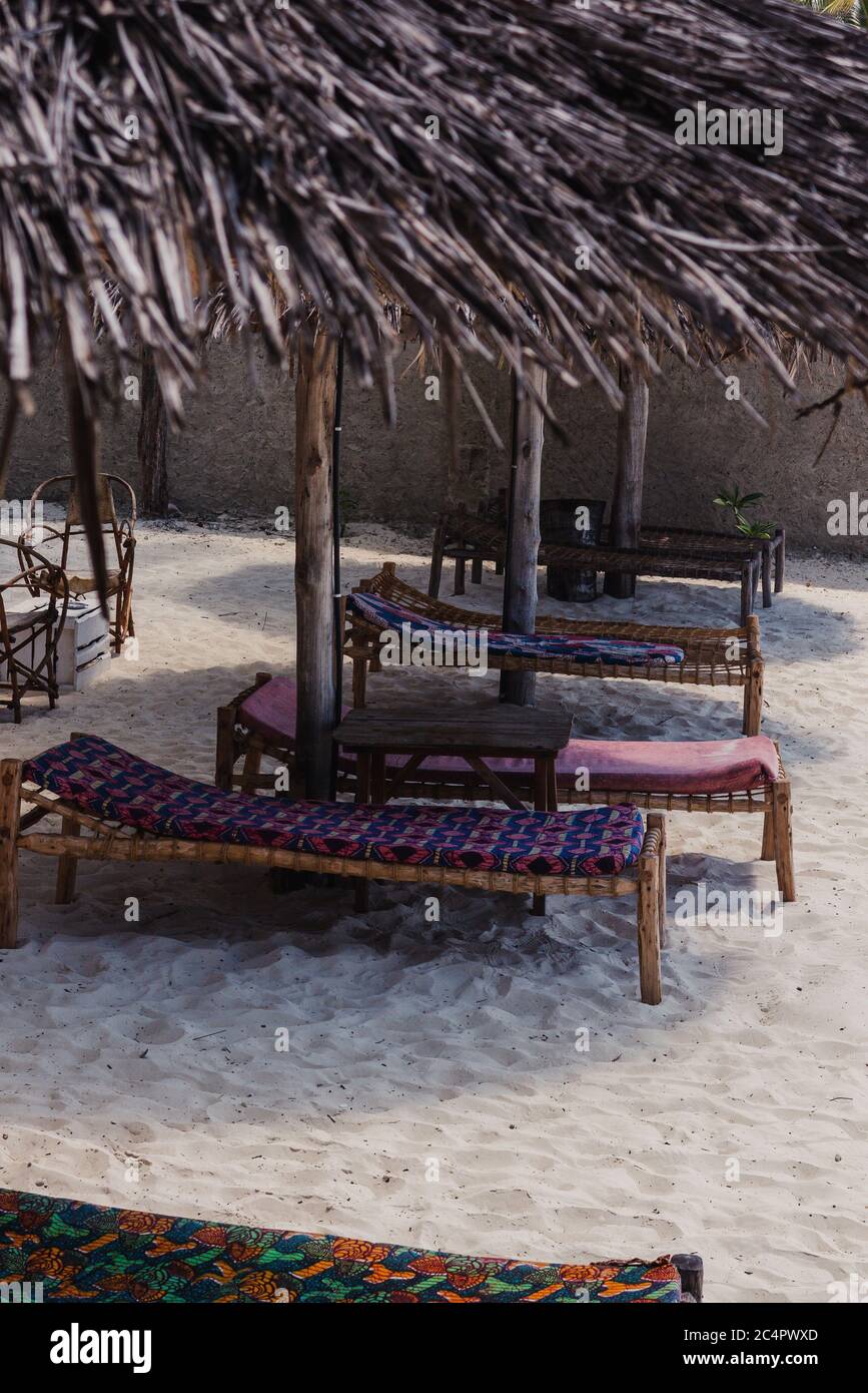 Color daybeds on the beach in Jambiani in Zanzibar, Tanzania Stock Photo