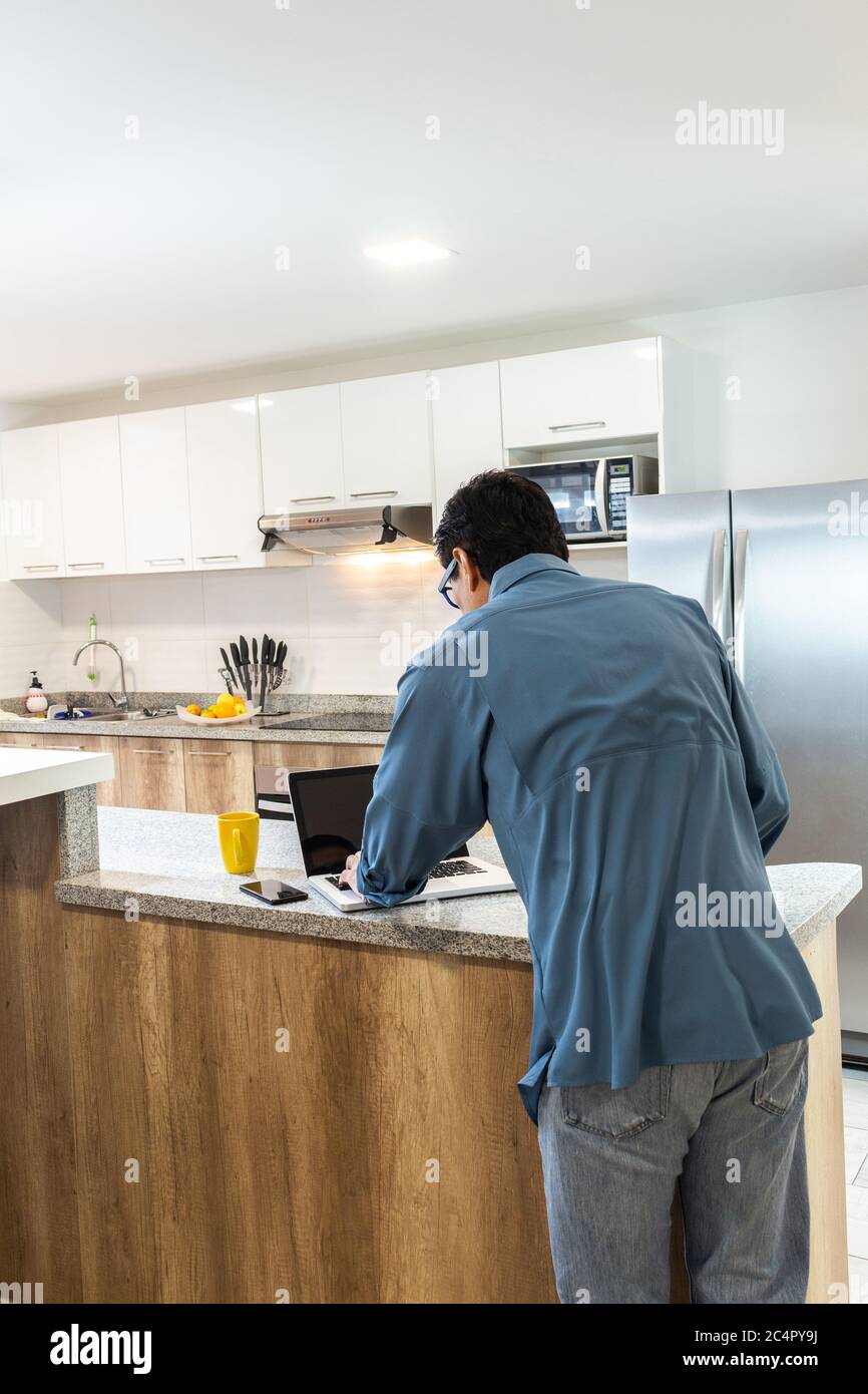 Man working at home on his laptop Stock Photo