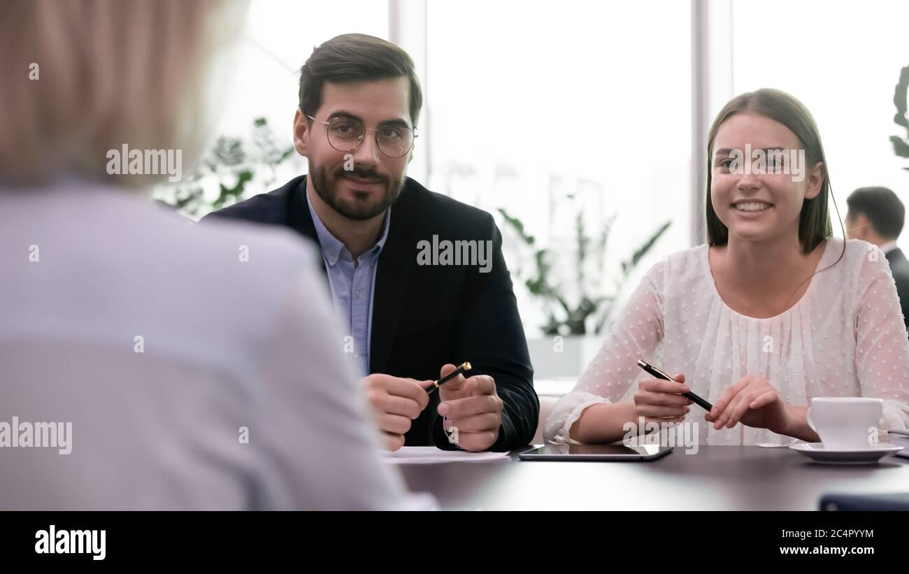 Successful job interview, two headhunters happy smiling listen to employee Stock Photo