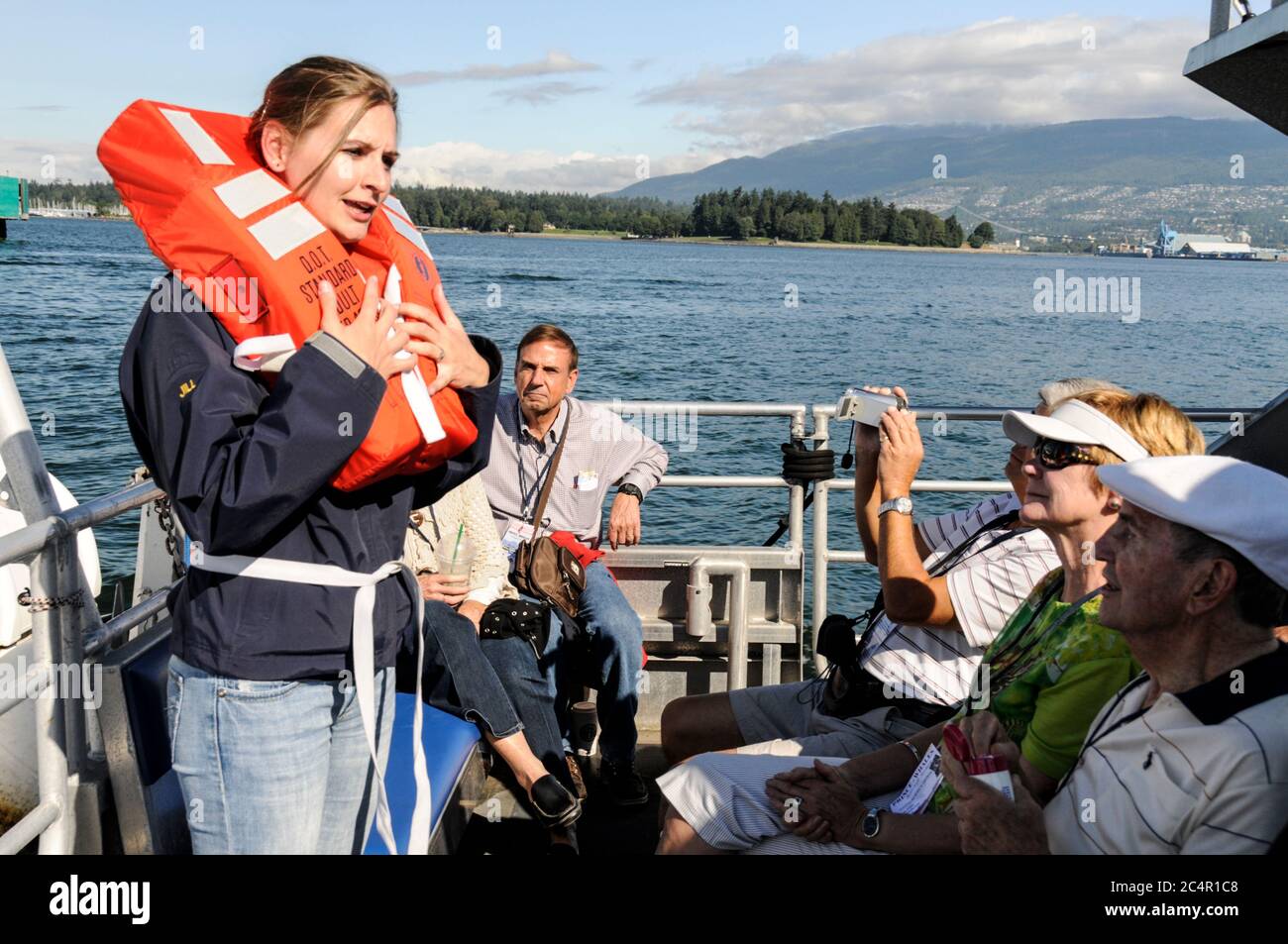 A crew member giving a sea safety drill to visitors on the Whale watching boat  in Vancouver, Canada Stock Photo