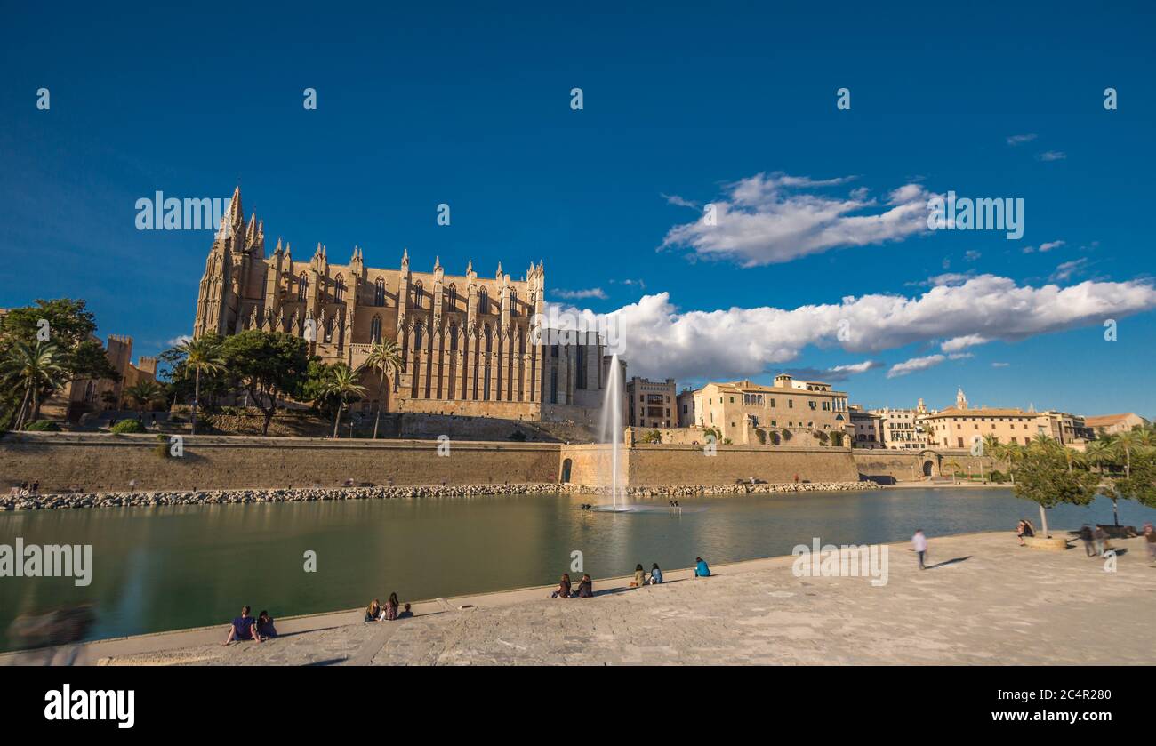 Panoramic view Palma de Mallorca Cathedral blue sky reflected in water Tourists and people walking and taking photos. Balearic islands of Spain Stock Photo
