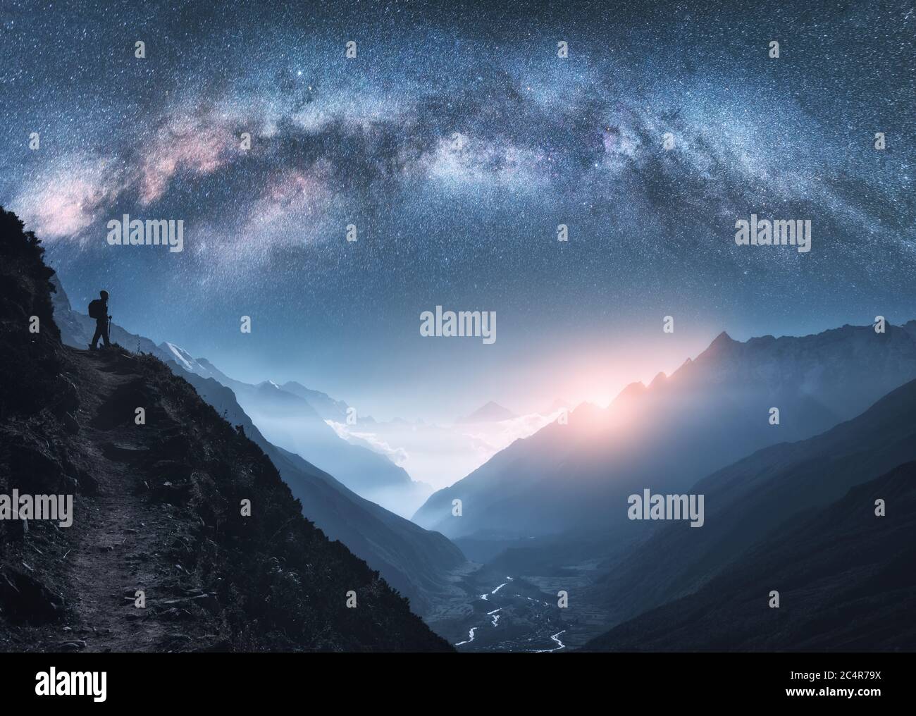 Arched Milky Way, woman and mountains at night Stock Photo