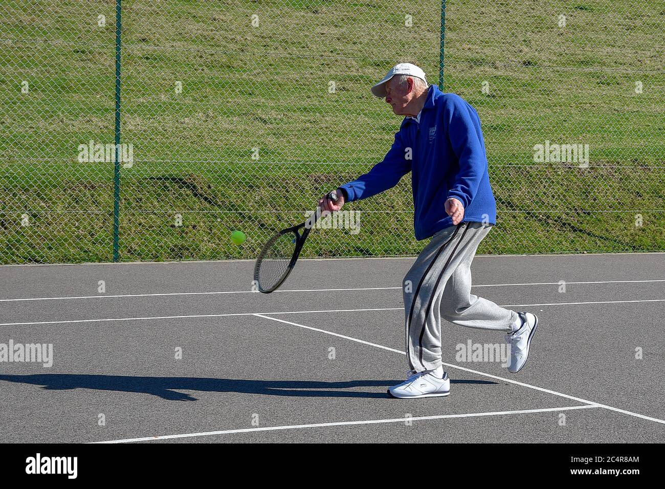 Retired elderly gentleman playing tennis. Stock Photo