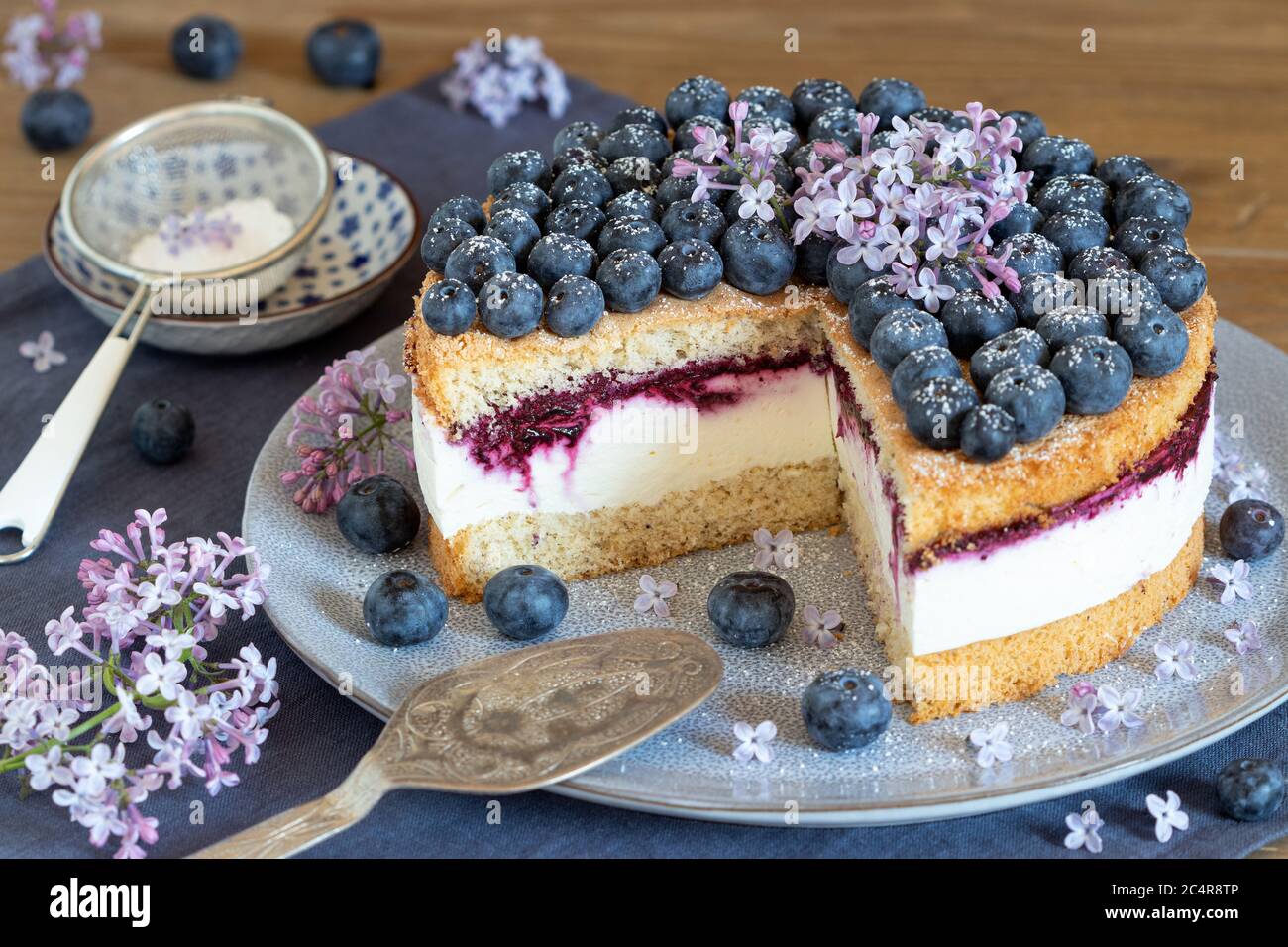 blueberry cake decorated with lilac flowers Stock Photo