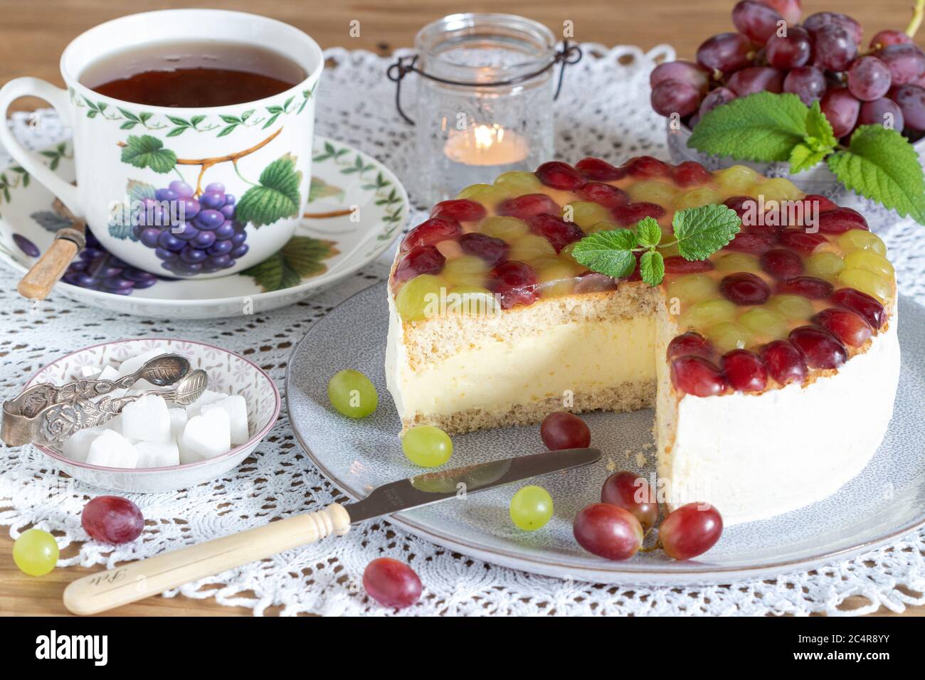 grape cream cake on plate and tea cup Stock Photo