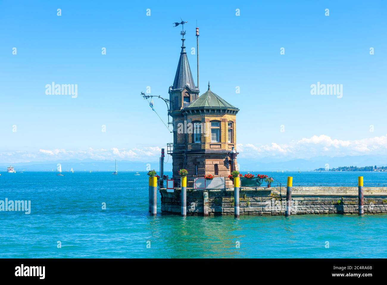 Lighthouse on old pier in harbor of Constance or Konstanz, Germany. Beautiful scenic view of Constance Lake (Bodensee) in summer. Scenery of vintage l Stock Photo