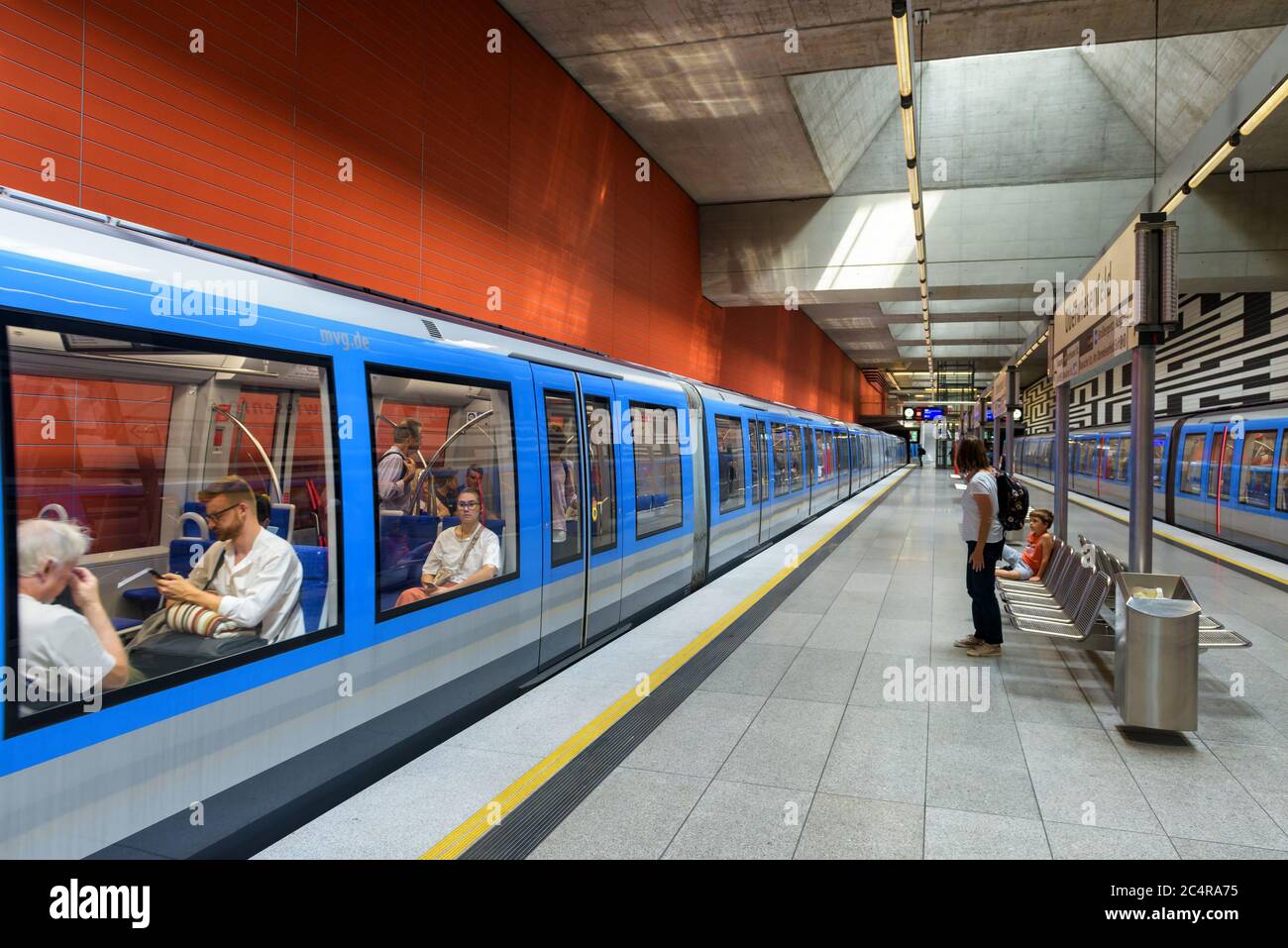 Munich, Germany - Aug 2, 2019: Inside the metro station in Munich. Train with passengers in modern subway. Panoramic view of platform of urban undergr Stock Photo
