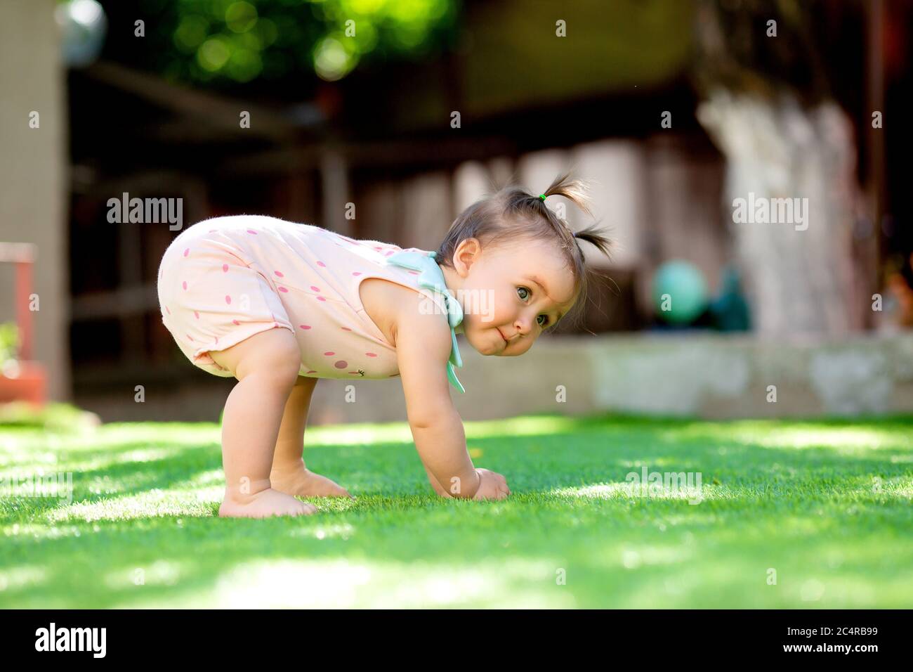 Toddler Girl Learns to Walk Stock Photo