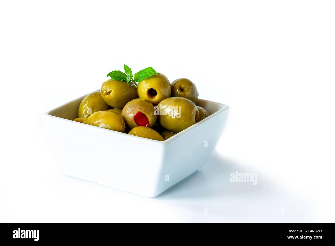 Green olives with pimento on white background Stock Photo Alamy