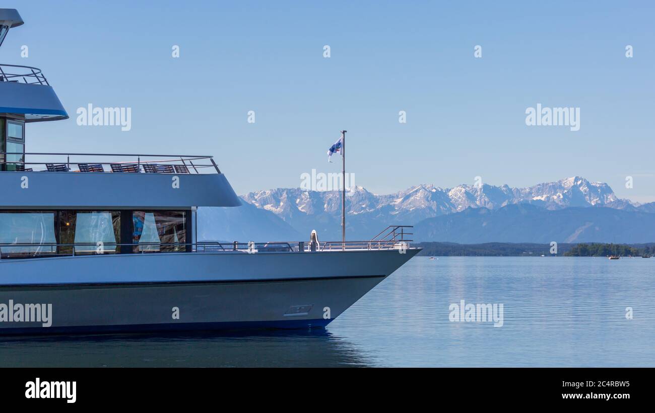Cruise boat at Lake Starnberg with snow capped Zugspitze mountain at the horizon. Stock Photo