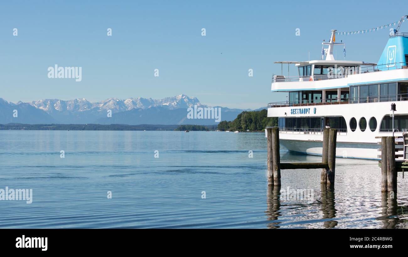 White cruise boat / steamer at Lake Starnberg. Alps with Zugspitze on the horizon. Stock Photo