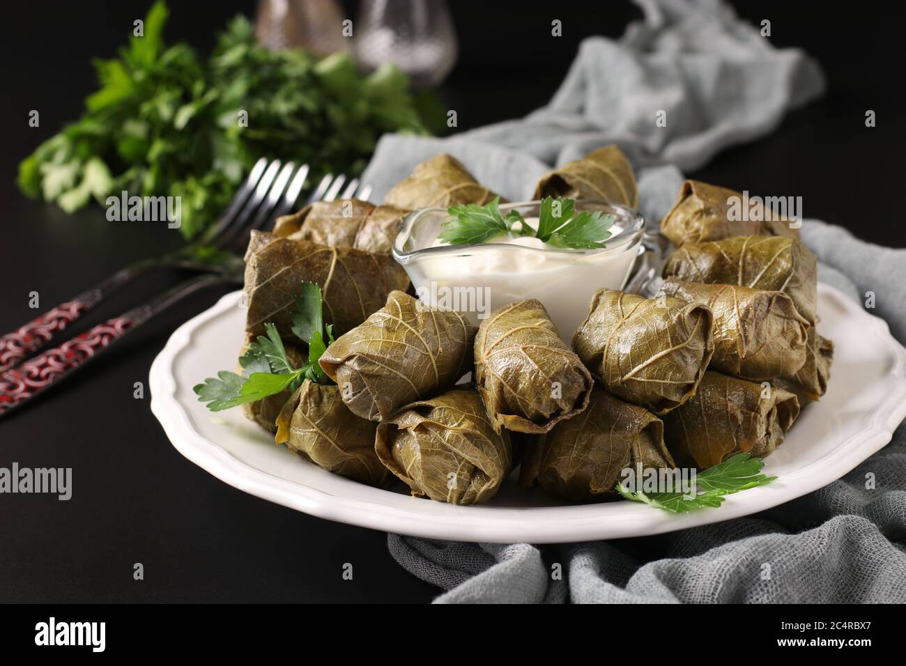 Dolma stuffed grape leaves with rice and meat on black background. Traditional Caucasian