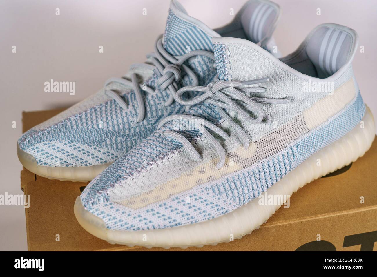 Moscow, Russia - June 2020 : Adidas Yeezy Boost 350 V2 Cloud White - Famous Limited Collection Fashion Sneakers by Kanye West and Adidas Collaboration, Trendy Sport Shoes. Stock Photo