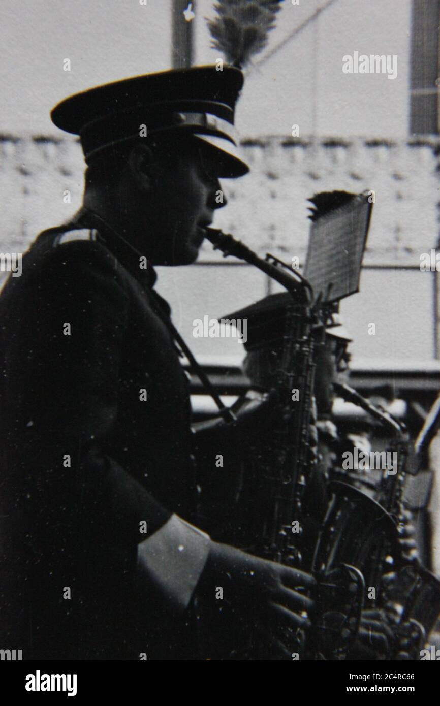 Fine 70s vintage black and white photography of a high school band saxophone player on parade in downtown Chicago, Illinois. Stock Photo