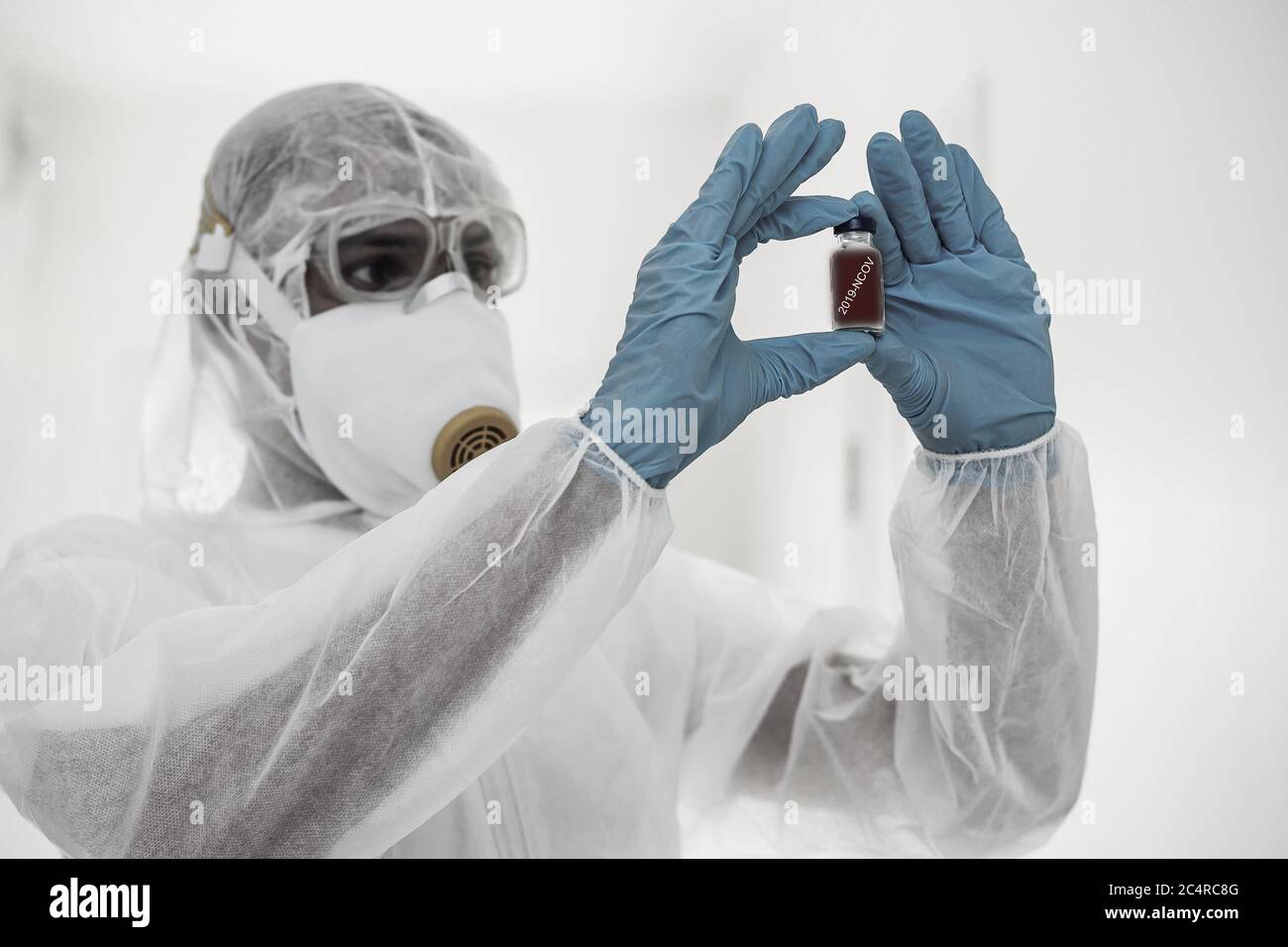 Man in protective clothing and a gasmask on a white background Stock Photo