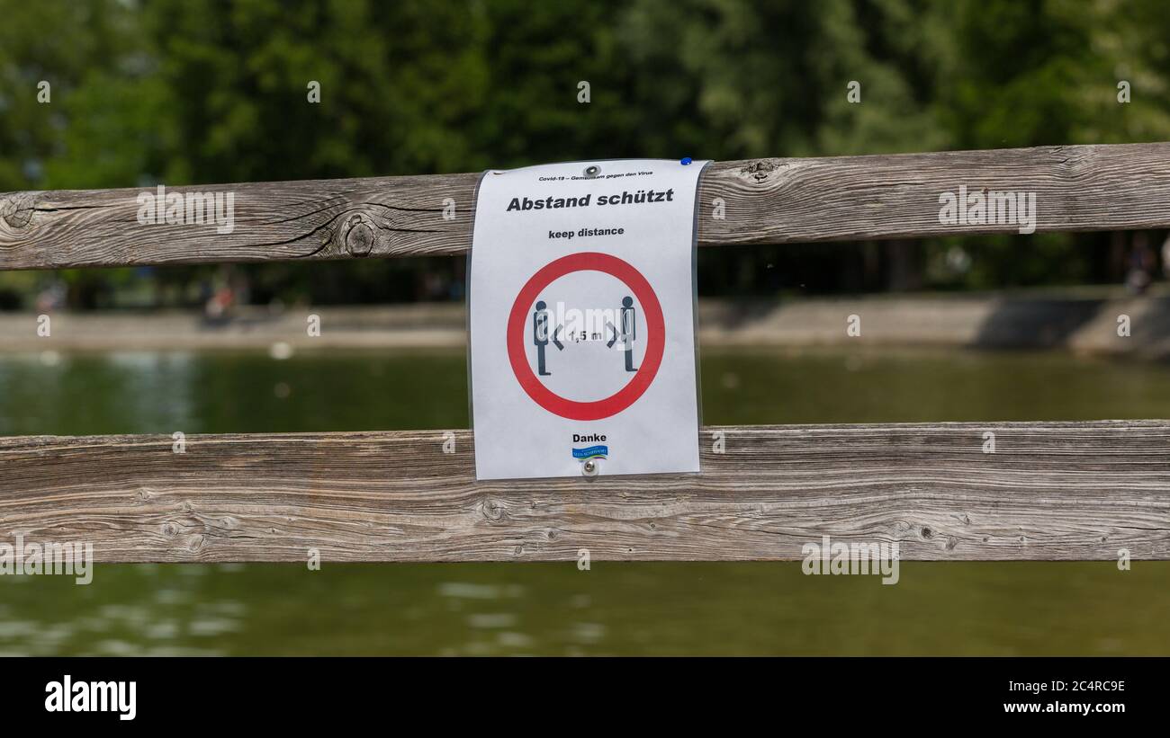 'Keep distance' sign at the main landing pier of Herrsching. To prevent spread of Covid-19. Every day several excursion boats depart from the pier. Stock Photo
