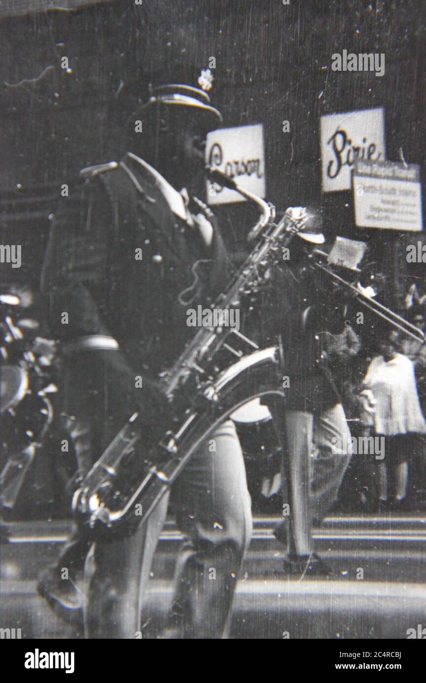 Fine 70s vintage black and white photography of a high school band saxophone player on parade in downtown Chicago, Illinois. Stock Photo
