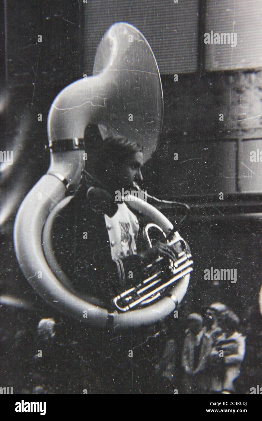 Fine 70s vintage black and white photography of a high school band tuba player on parade in downtown Chicago, Illinois. Stock Photo